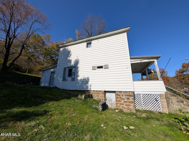 rear view of property with a lawn