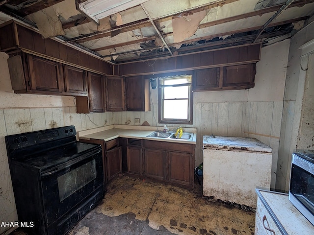 kitchen featuring dark brown cabinets, black electric range oven, and sink