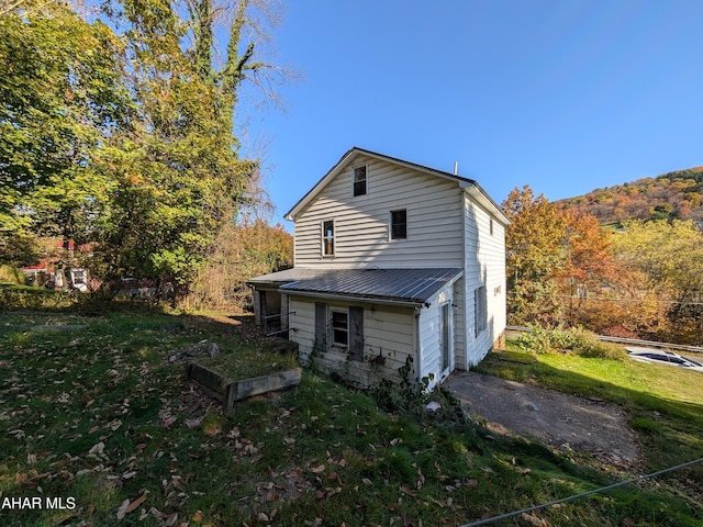 rear view of house with a yard