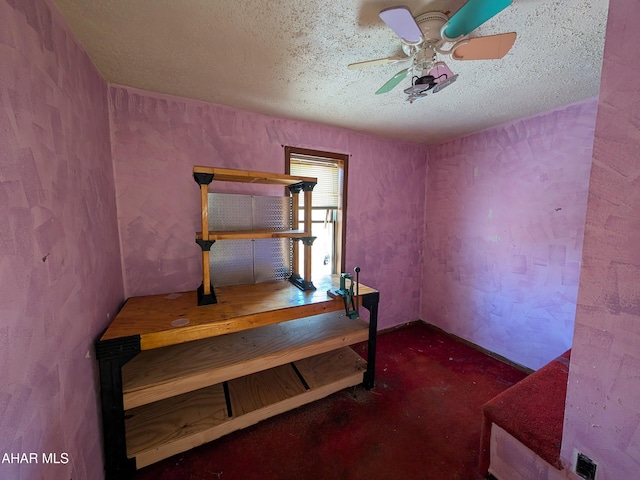 carpeted bedroom with ceiling fan and a textured ceiling