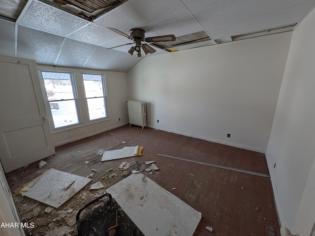 bonus room with vaulted ceiling, ceiling fan, and radiator heating unit