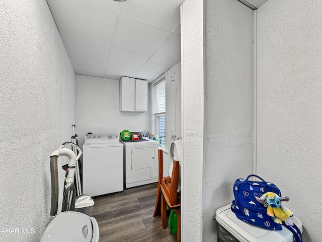 laundry room featuring cabinets, dark hardwood / wood-style flooring, and washer and clothes dryer