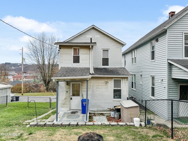 rear view of property with a yard