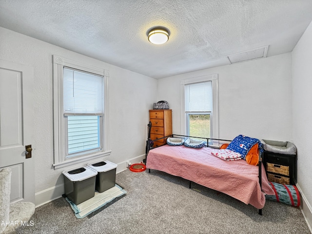 bedroom with carpet and a textured ceiling