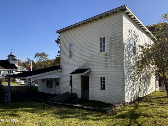 back of property featuring a yard