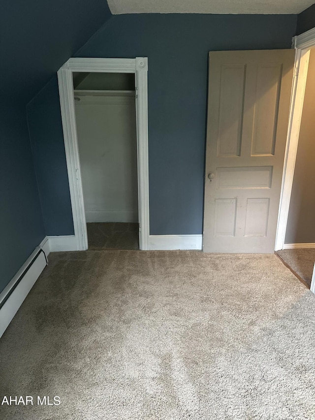 unfurnished bedroom featuring carpet, lofted ceiling, and a baseboard radiator