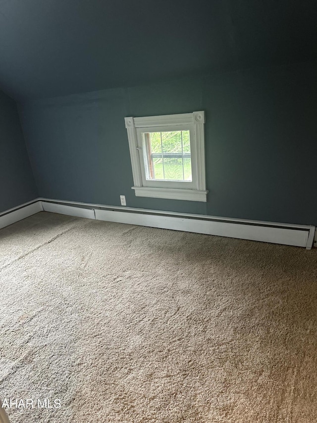 additional living space featuring carpet flooring and vaulted ceiling