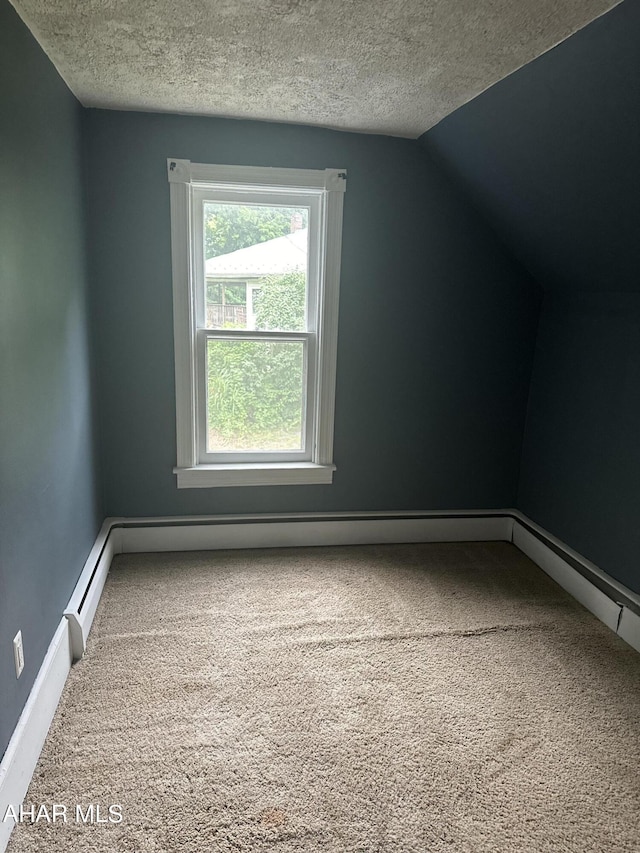 bonus room featuring carpet floors, a textured ceiling, a baseboard radiator, and vaulted ceiling