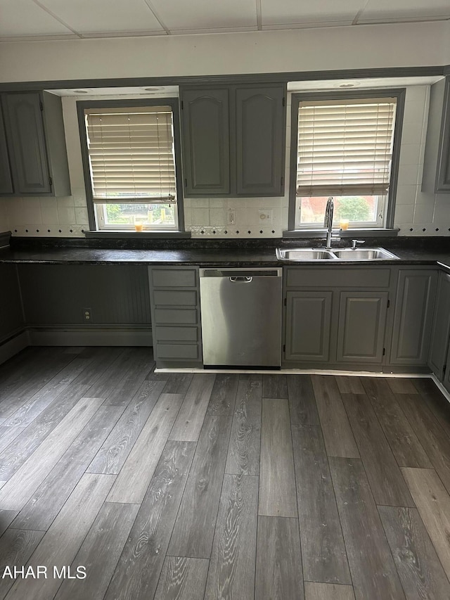 kitchen with gray cabinetry, dishwasher, dark hardwood / wood-style floors, and sink