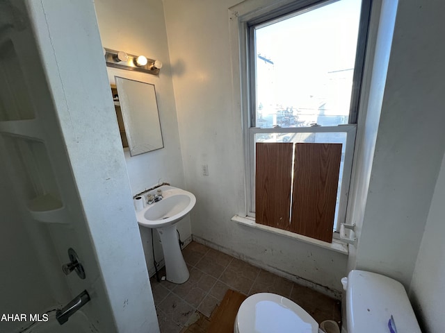 bathroom featuring tile patterned floors and toilet