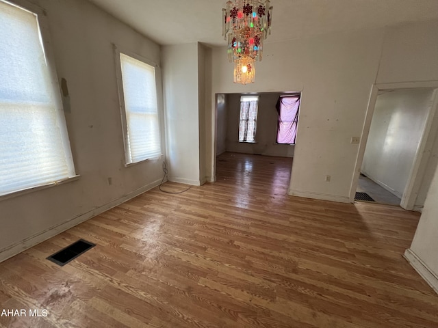 unfurnished dining area featuring a healthy amount of sunlight and wood-type flooring