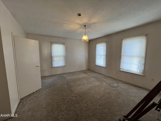 carpeted empty room featuring a healthy amount of sunlight