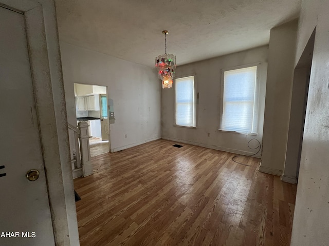 unfurnished dining area with hardwood / wood-style floors