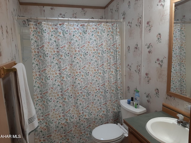 bathroom featuring vanity, toilet, curtained shower, and crown molding