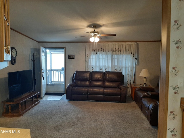 carpeted living room with a textured ceiling, ceiling fan, and ornamental molding