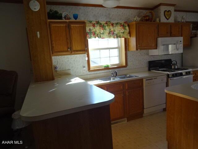 kitchen featuring sink and white appliances