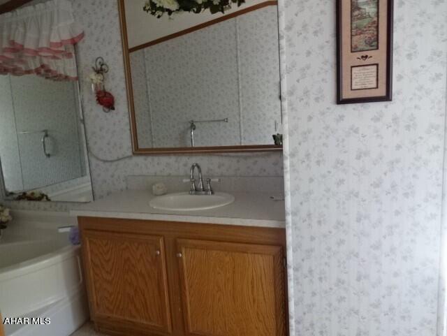 bathroom featuring a bathing tub and vanity