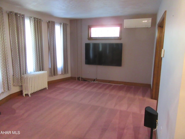 unfurnished room featuring a wall mounted air conditioner, radiator heating unit, and carpet