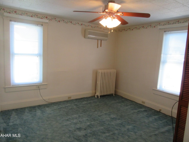 empty room featuring dark carpet, radiator heating unit, an AC wall unit, and a healthy amount of sunlight