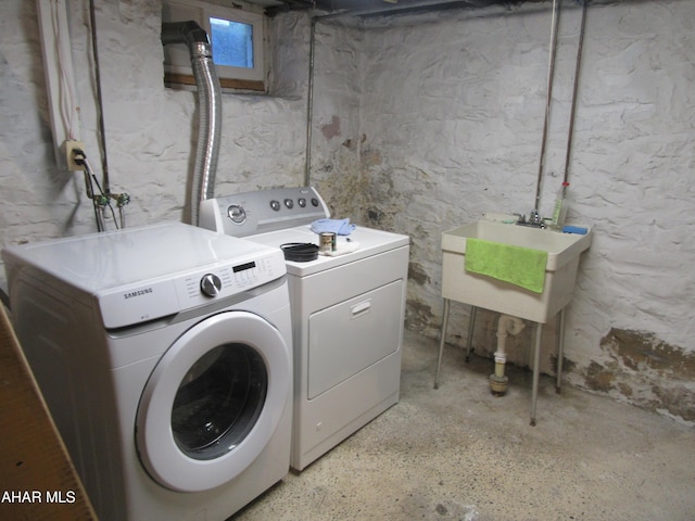 laundry room with washer and clothes dryer and sink