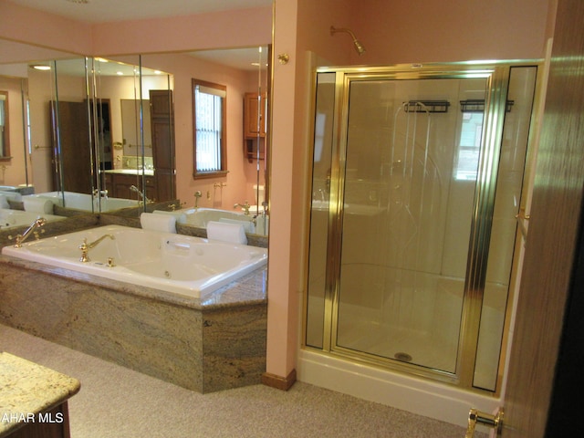 bathroom featuring vanity and independent shower and bath