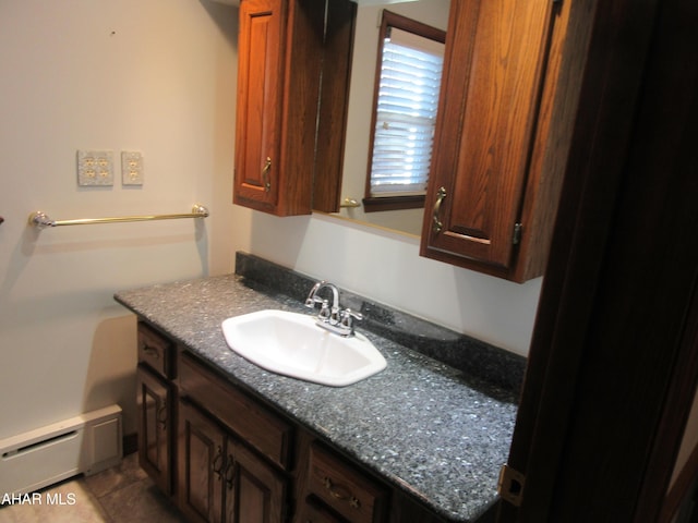 bathroom featuring tile patterned flooring, vanity, and a baseboard heating unit