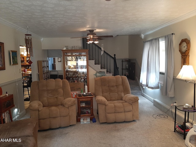 living room featuring carpet, ceiling fan, crown molding, and a textured ceiling