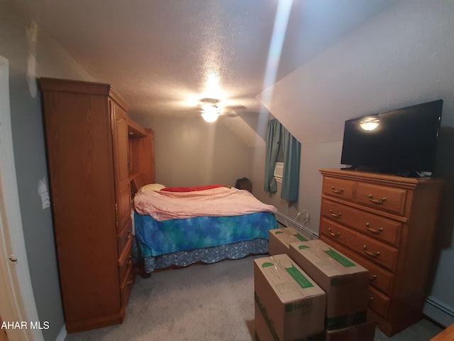 carpeted bedroom featuring baseboard heating, a textured ceiling, and vaulted ceiling