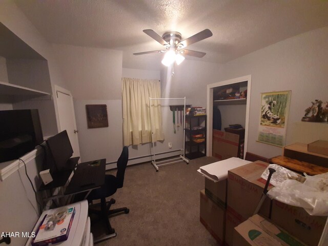 office area with carpet flooring, ceiling fan, a textured ceiling, and baseboard heating