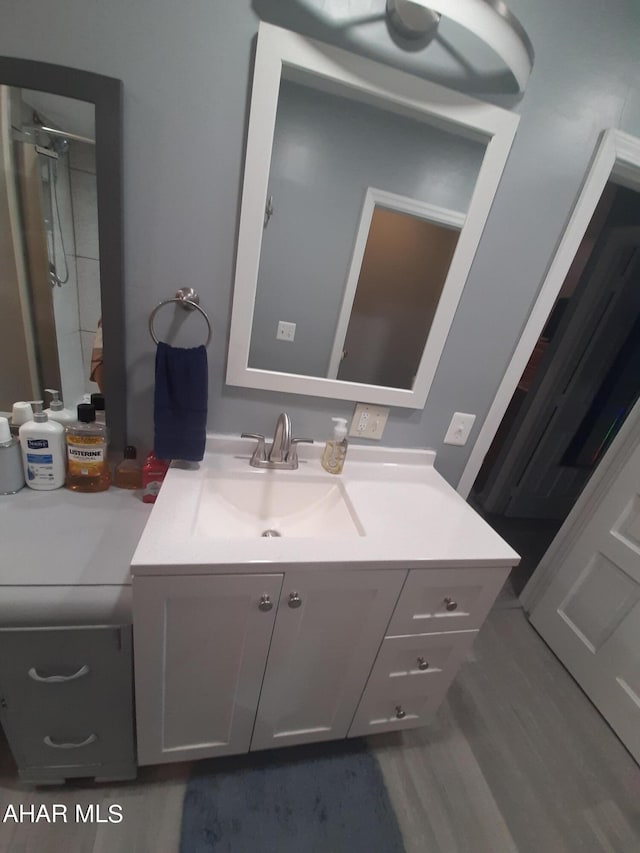 bathroom with vanity and wood-type flooring