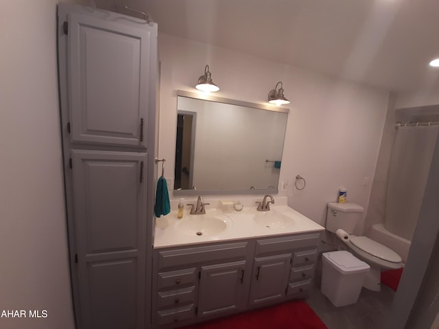 full bathroom featuring vanity, shower / bath combination with curtain, and toilet