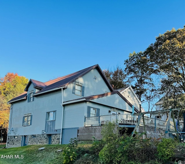 view of property exterior with a deck