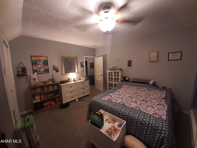 bedroom with a textured ceiling, ceiling fan, carpet, and vaulted ceiling