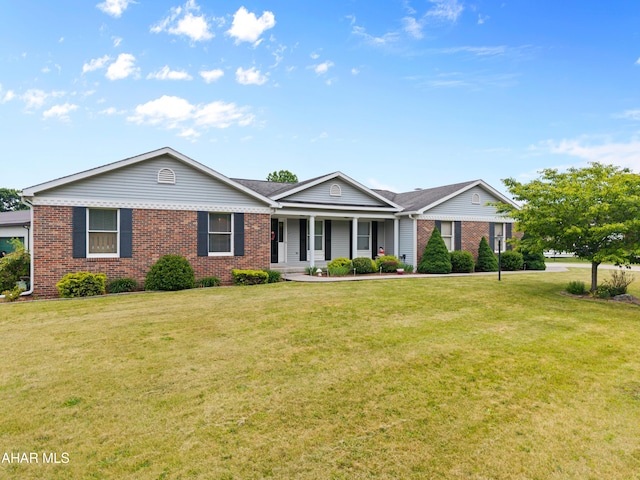409 Tree Ln, Duncansville, PA 16635 - ranch-style home with brick siding, a front lawn, and covered porch