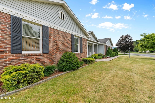 409 Tree Ln, Duncansville, PA 16635 - view of side of home featuring brick siding and a lawn