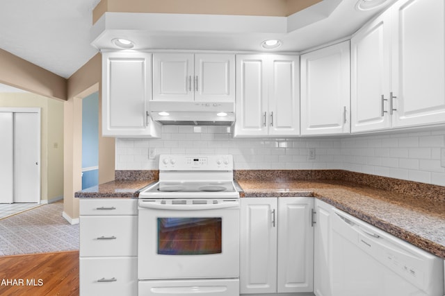 409 Tree Ln, Duncansville, PA 16635 - kitchen featuring white appliances, under cabinet range hood, white cabinetry, dark countertops, and backsplash