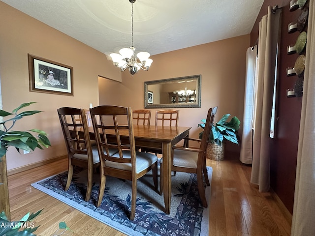 3406 Granada Way, Altoona, PA 16601 - dining room with a chandelier, wood finished floors, and baseboards