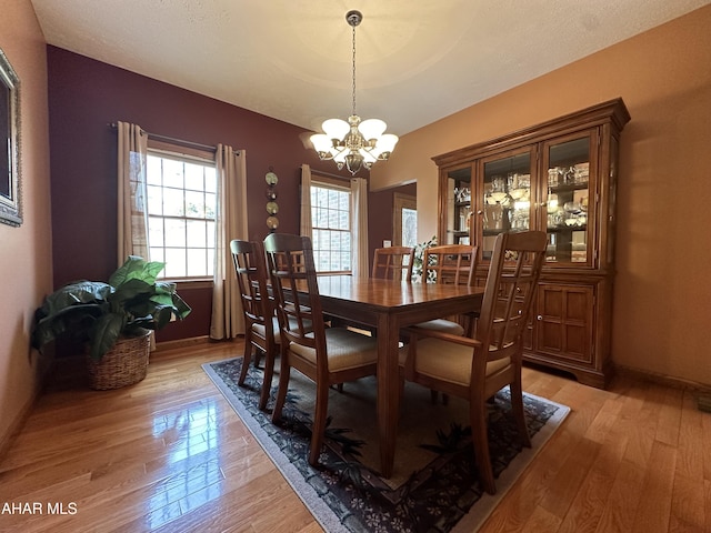 3406 Granada Way, Altoona, PA 16601 - dining room with a chandelier, light wood-style floors, and baseboards