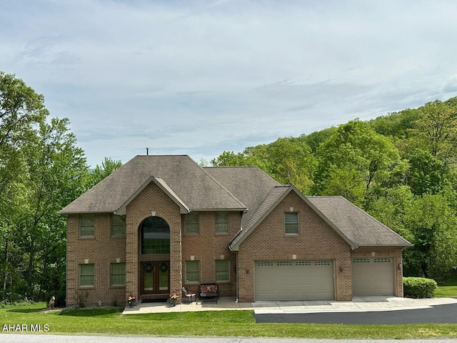 3406 Granada Way, Altoona, PA 16601 - traditional-style house with french doors, a front yard, brick siding, a garage, and a shingled roof