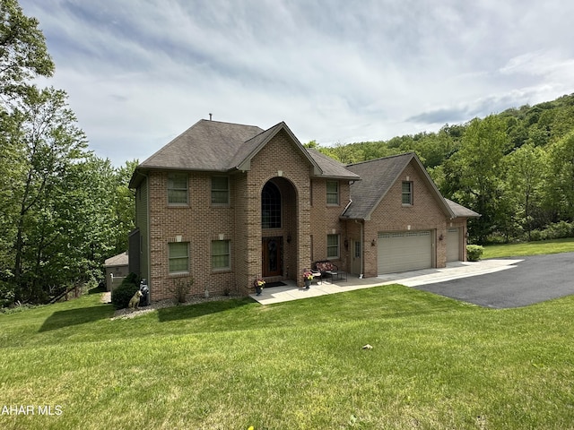 3406 Granada Way, Altoona, PA 16601 - view of front of house with brick siding, driveway, and a front yard