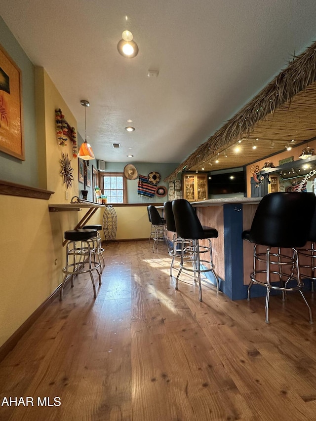3406 Granada Way, Altoona, PA 16601 - kitchen featuring hardwood / wood-style flooring, a kitchen breakfast bar, and baseboards