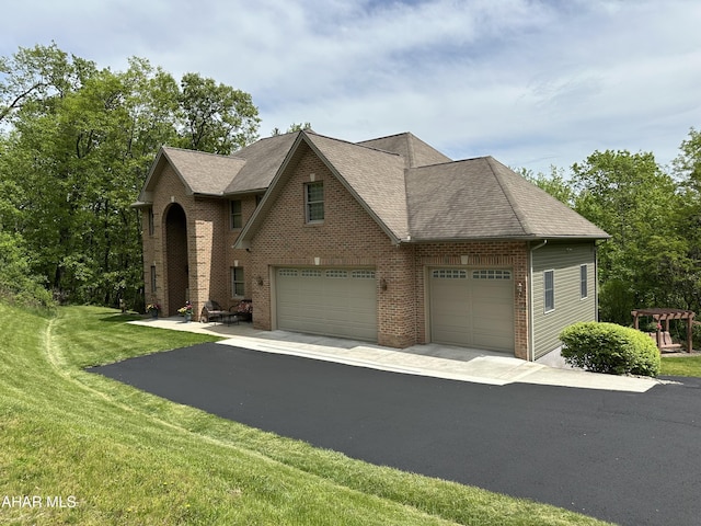 3406 Granada Way, Altoona, PA 16601 - view of front facade with brick siding, a front yard, driveway, and a shingled roof