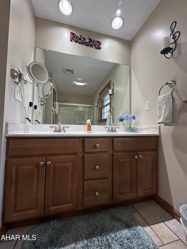 3406 Granada Way, Altoona, PA 16601 - full bath featuring a stall shower, double vanity, tile patterned floors, baseboards, and a textured ceiling