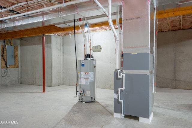 basement featuring electric panel, heating unit, and water heater