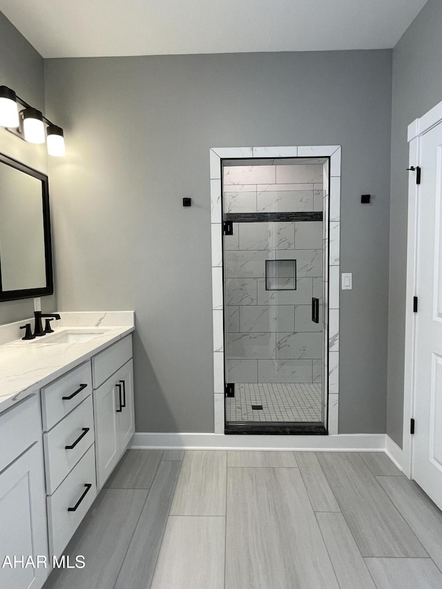 bathroom with vanity and a shower with shower door