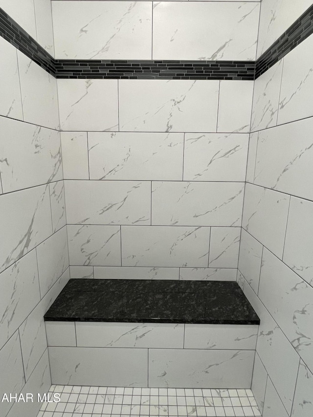 bathroom with a tile shower