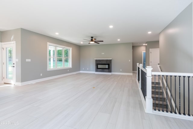 unfurnished living room featuring ceiling fan