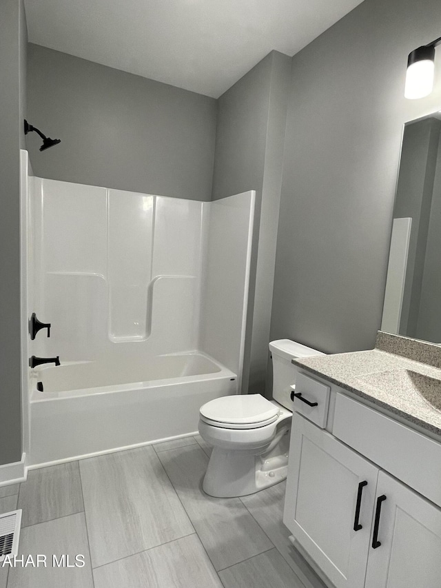 full bathroom featuring vanity, bathtub / shower combination, and toilet