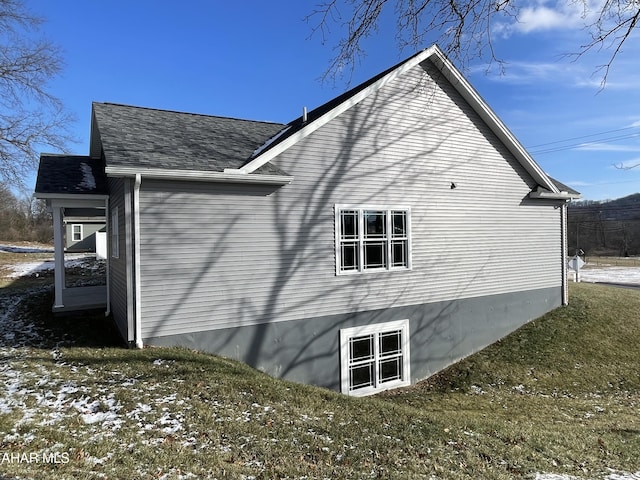 view of side of property featuring a yard