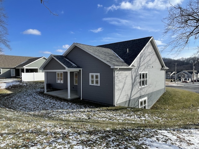 view of snow covered back of property